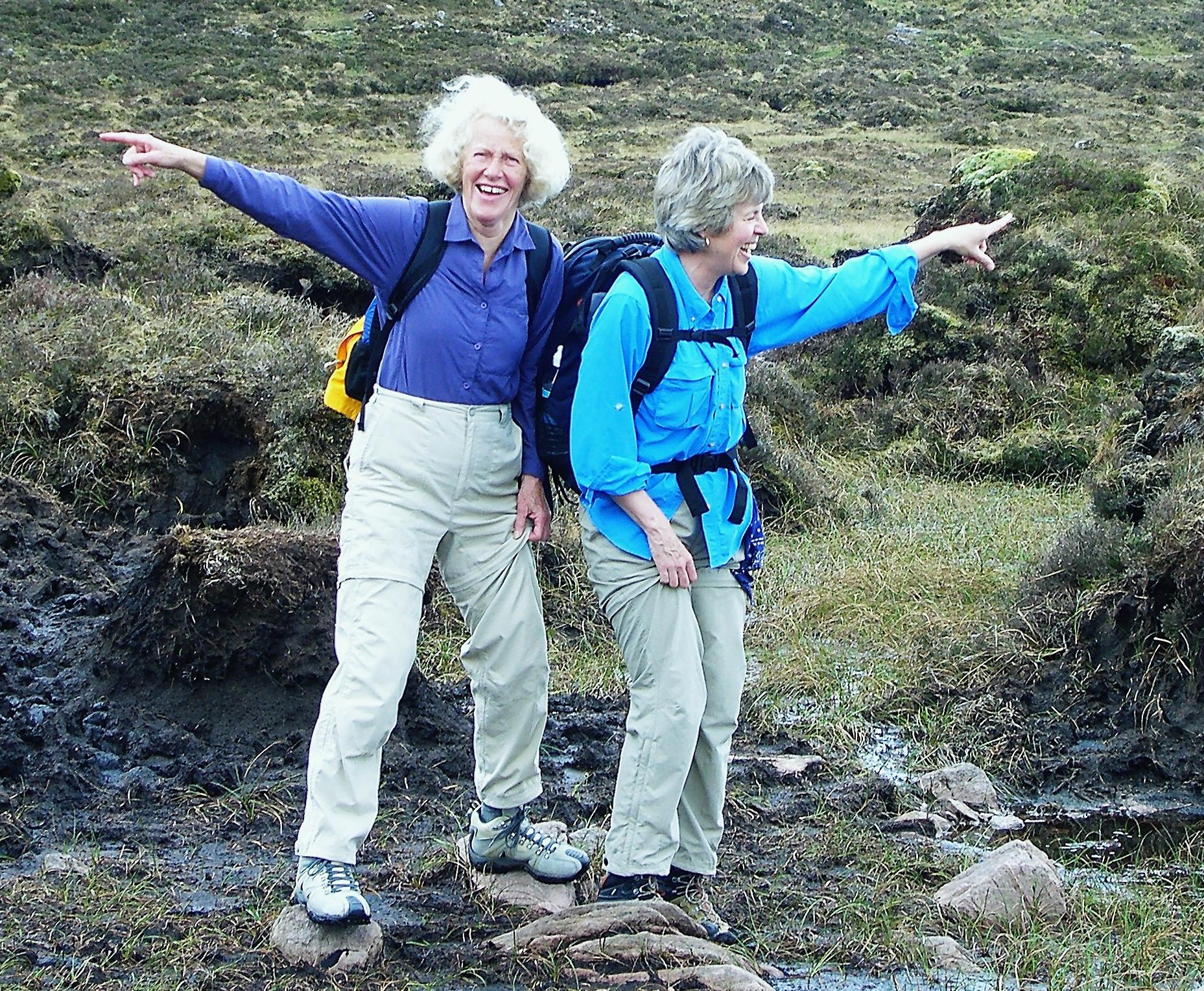 Anne and Deborah giving directions while hiking in Irish bog