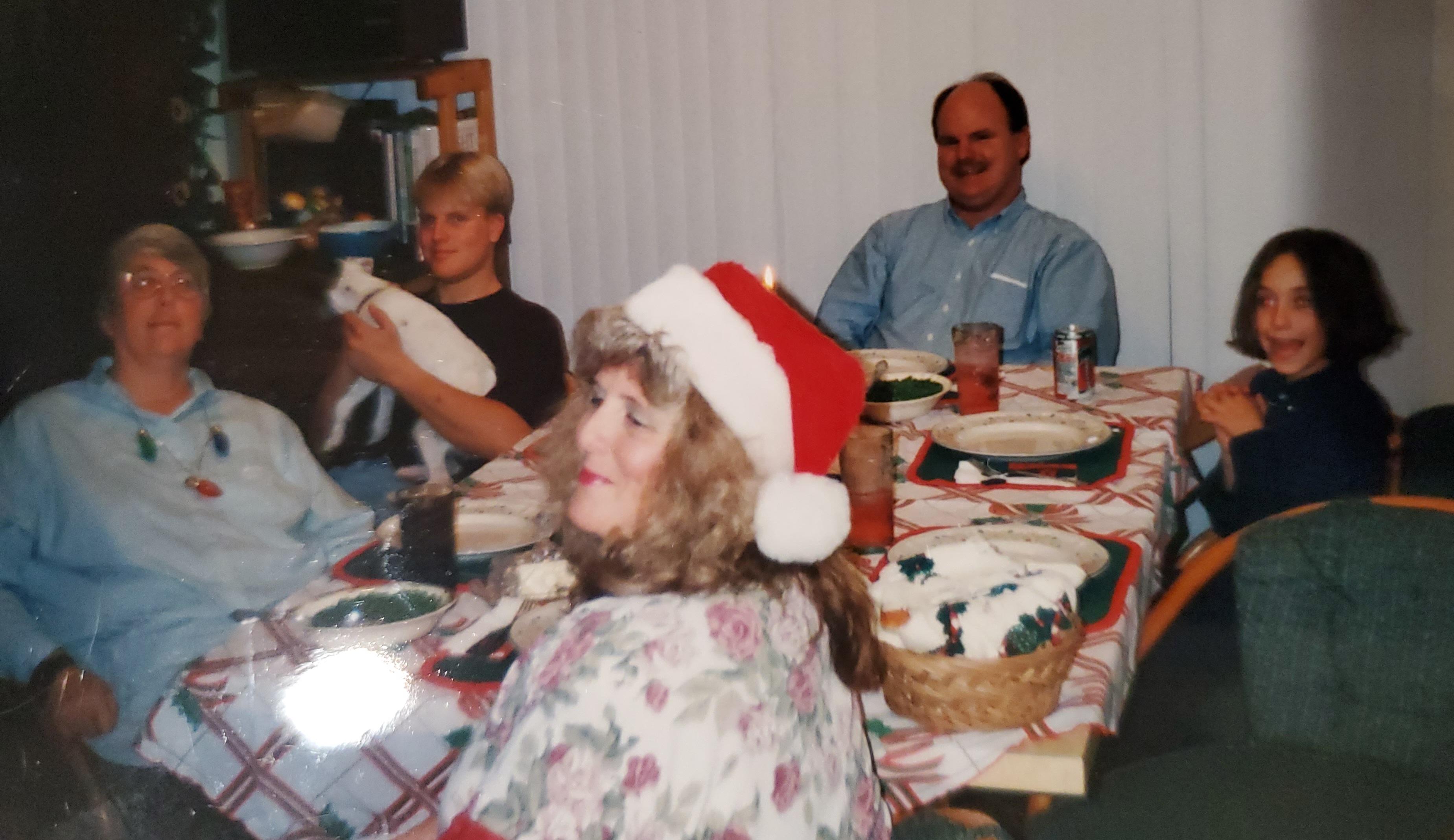 Christmas dinner 1994. Carole at far left, then her nephew Travis holding one of our dogs, then her brother-in-law Wesley, then her niece April and Lora. I think that Nathan must have been taking the picture. K loved a good home cooked meal and we shared many around that table. 