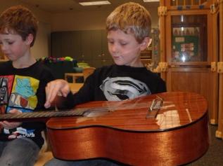 Trying the guitar in class