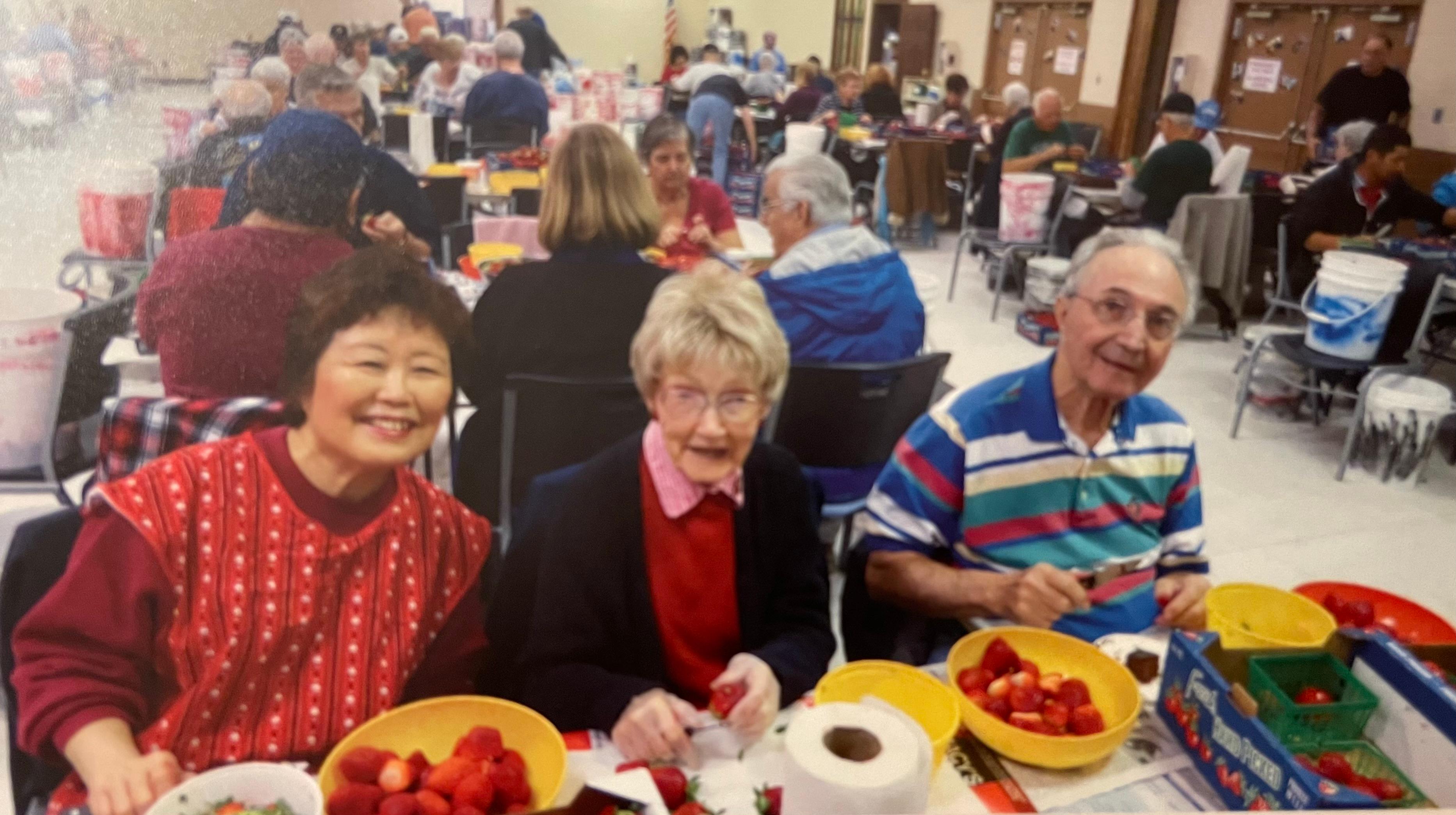 Michiko, Jerry & Sam cleaning strawberries for the annual Strawberry Festival in Florida.