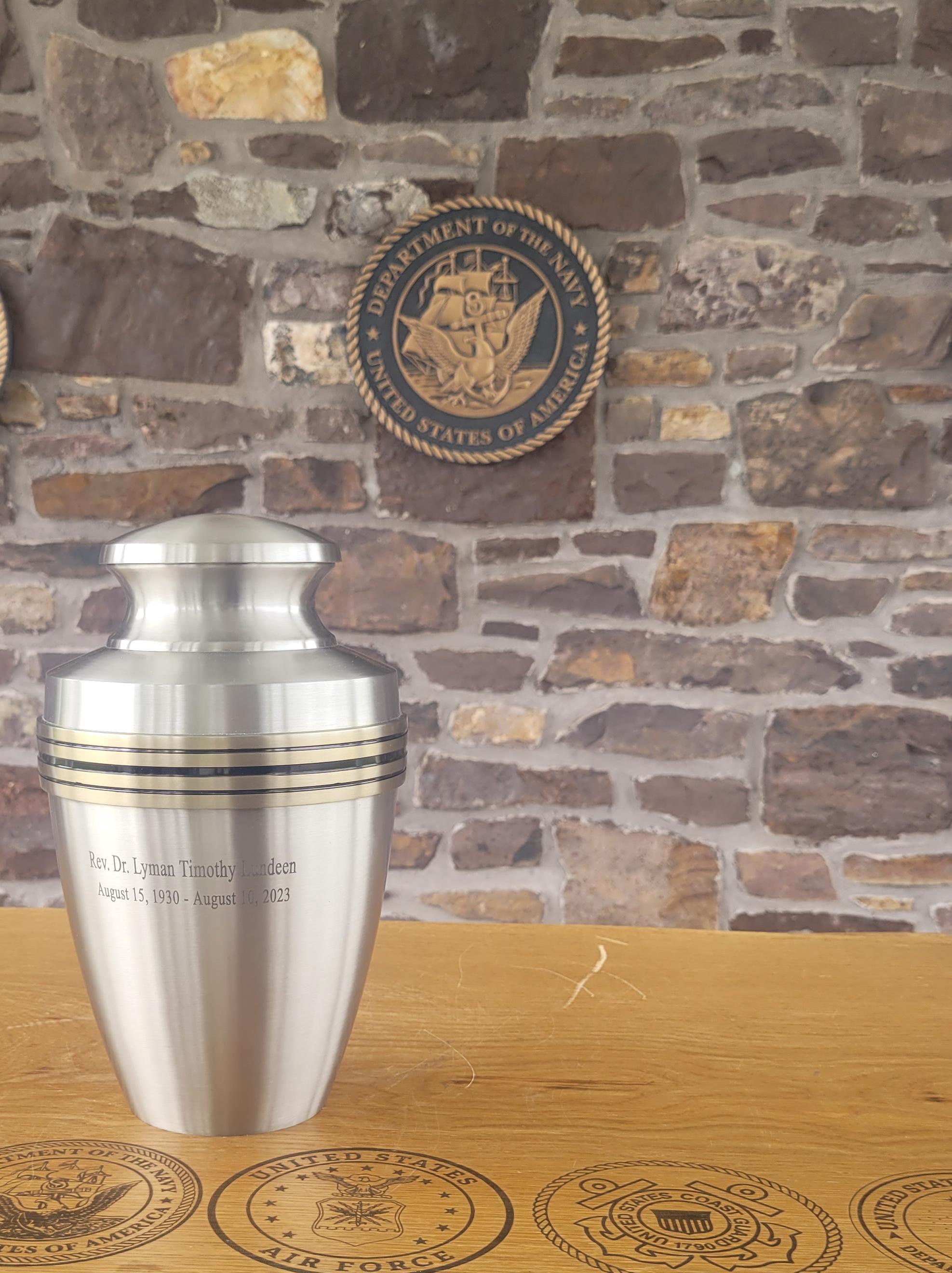 Lyman's urn standing in front of the Naval Seal