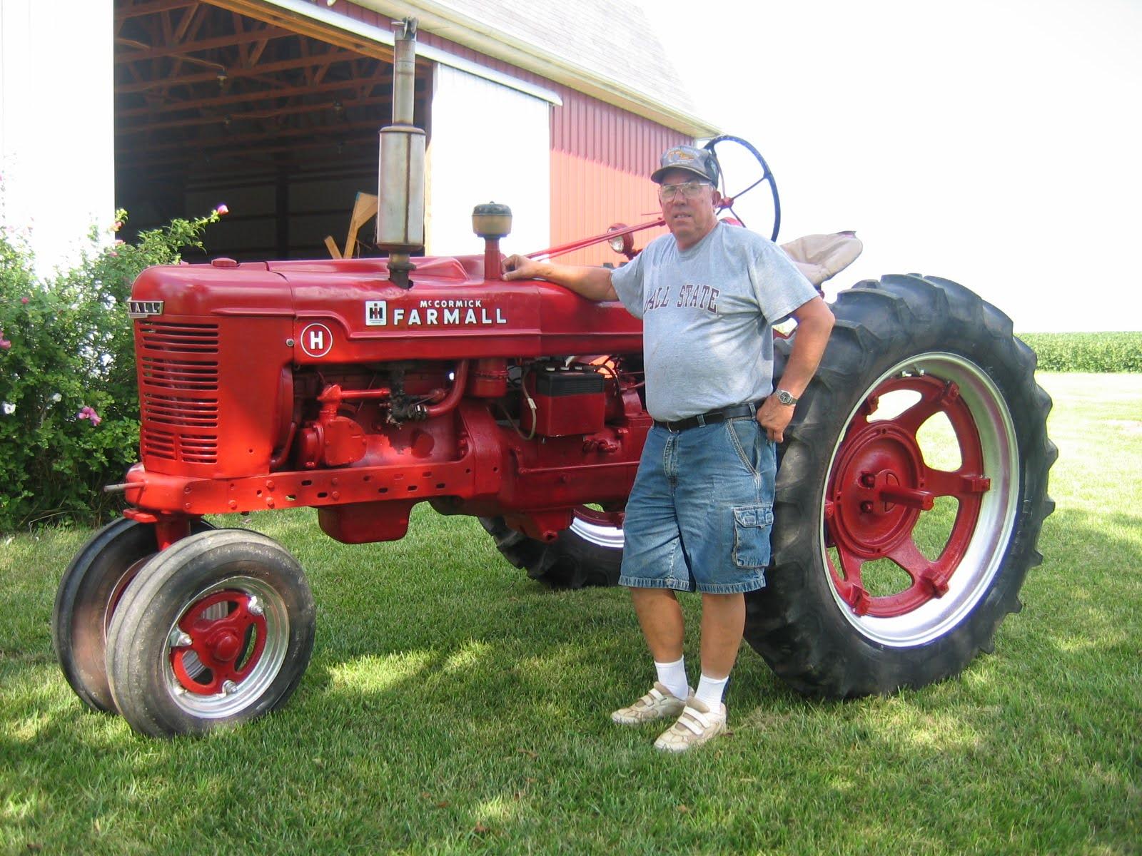 Jerry with one of his many tractors that he had on the family farm, where he loved to work on the engines and fix them up (August 2005)