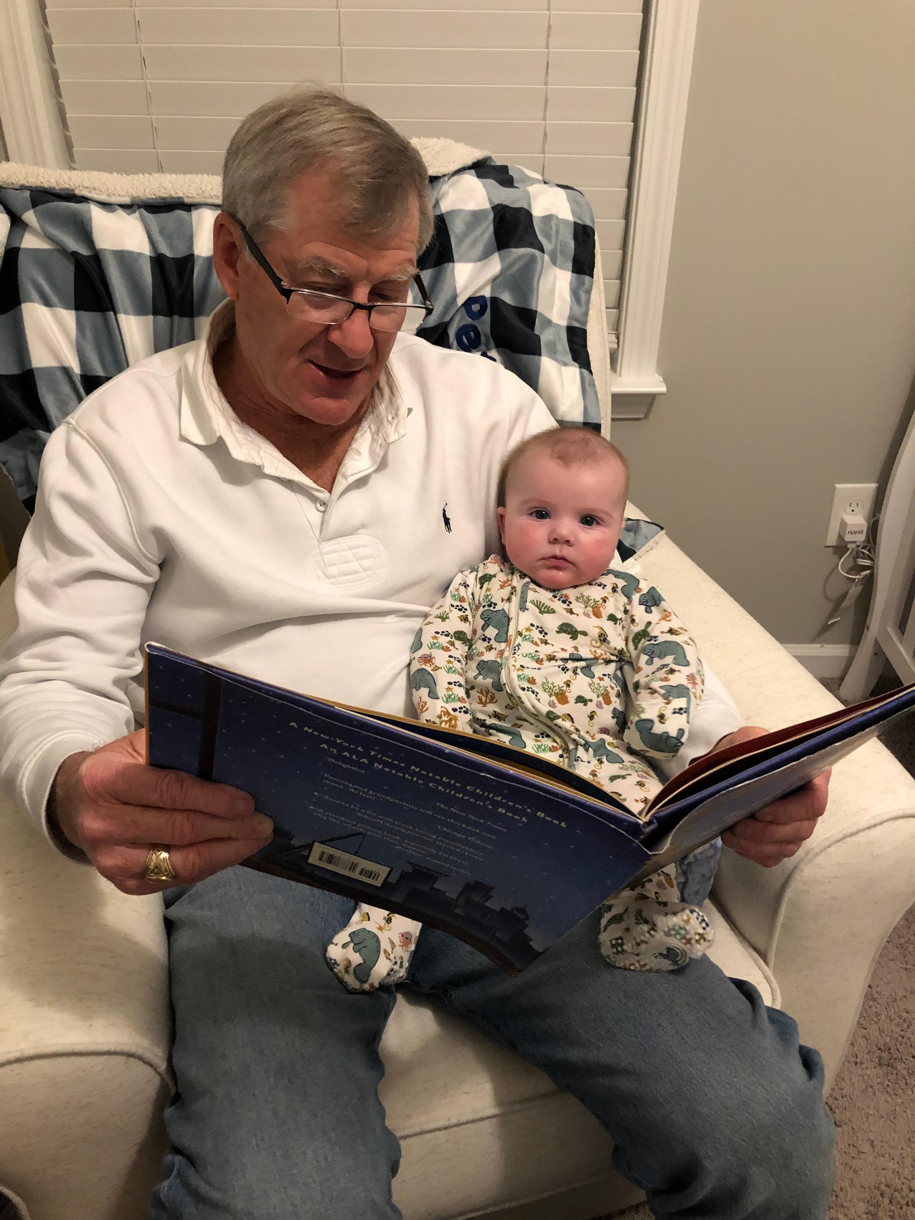 Two Peters read Goodnight, Goodnight, Construction Site. Dad with grandson, Peter.