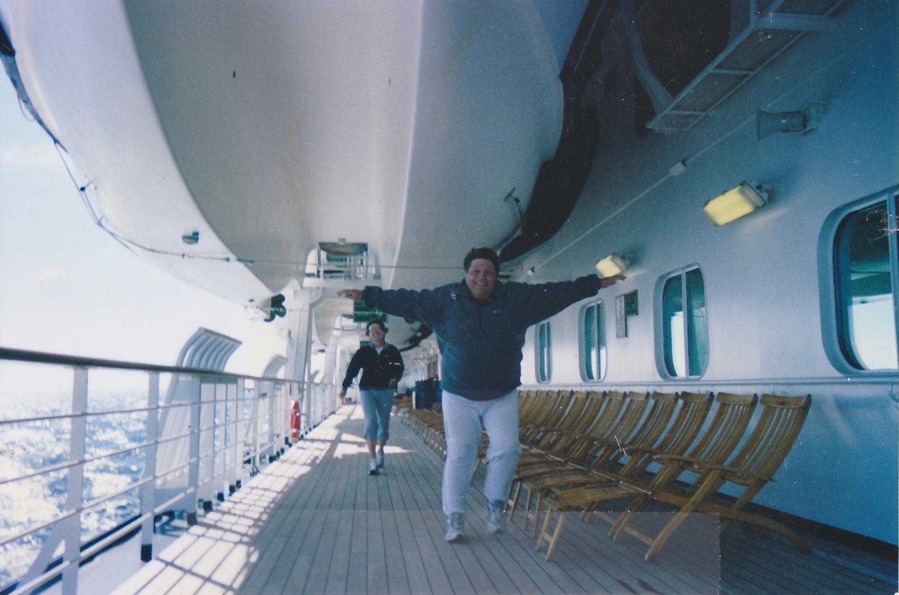 Pretending to beat his sister, Linda, at a race around our cruise ship.