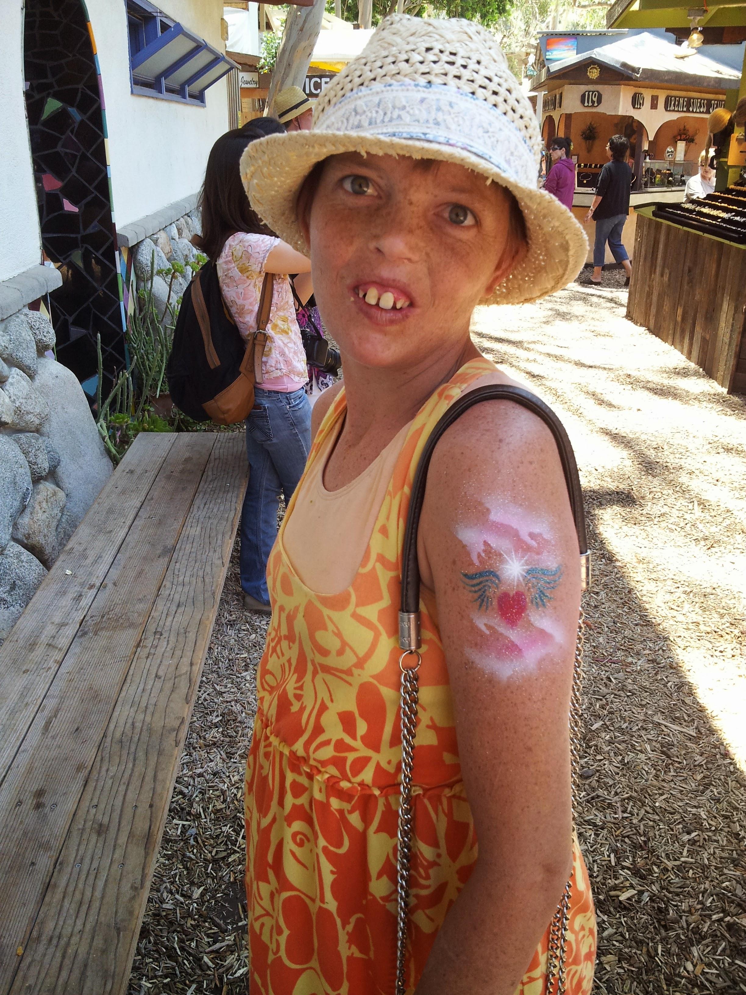 Ashley LOVED getting airbrush tattoos at the Sawdust Festival by a man named Starr. She would get hearts, Tinkerbell, then stuck with Ariel. She would show it off to strangers and they would always "ooo" and "aw."