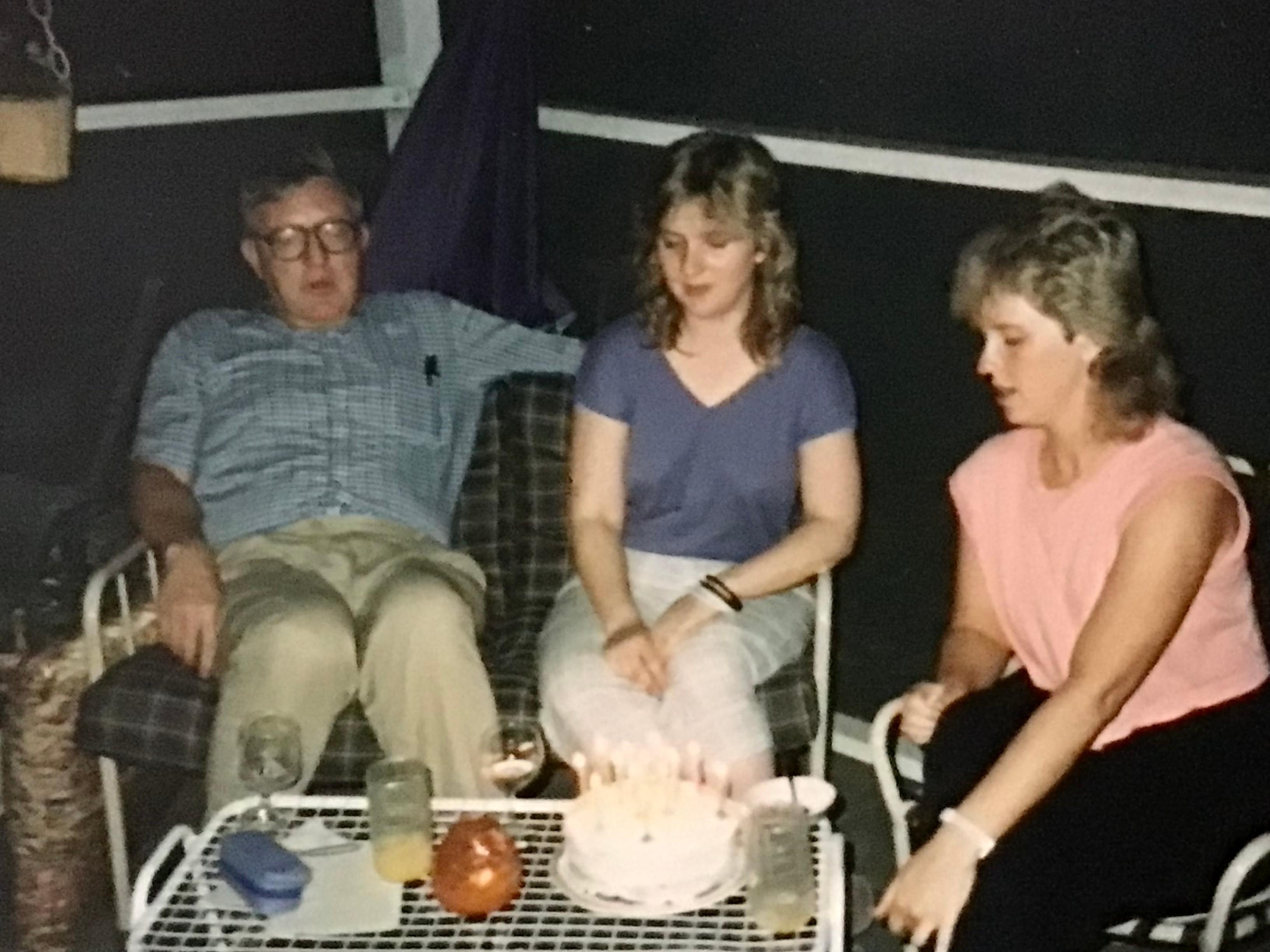 It’s a twin birthday - dad with Karla, Karen, and a cake.