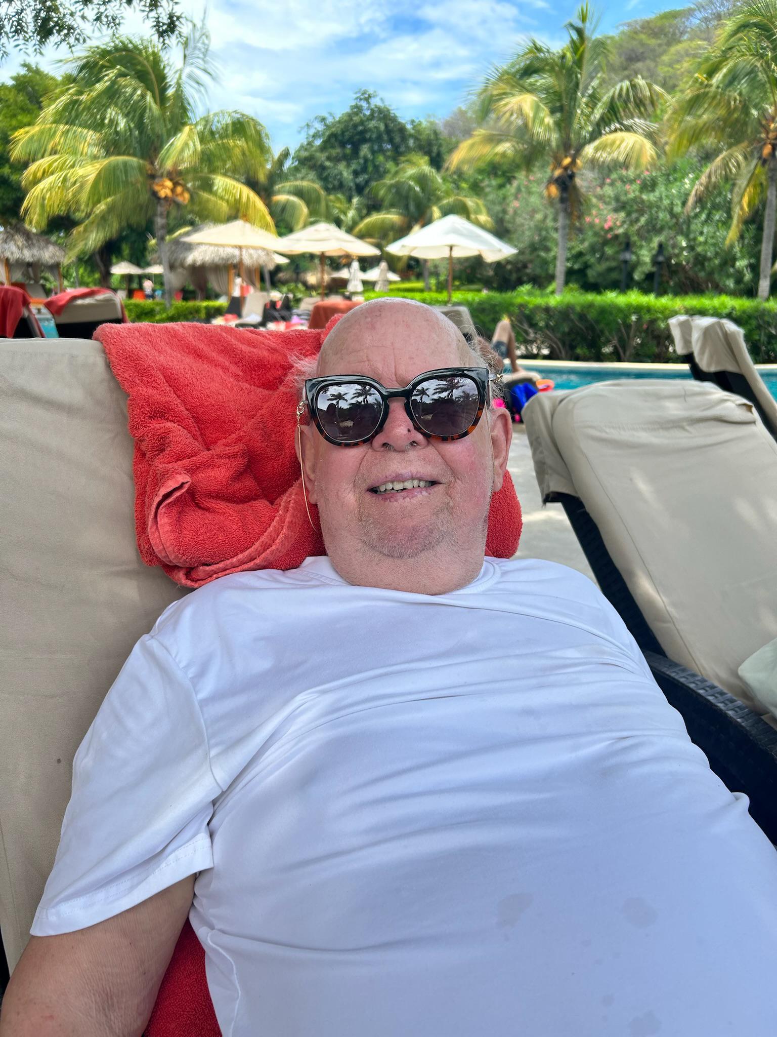 Dad chilling by the pools in Costa Rica, just soaking up the sun and watching the grandkids play.
