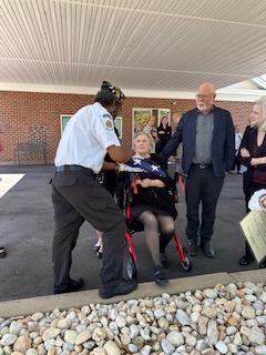 Grace accepting Lyman's military honor flag
