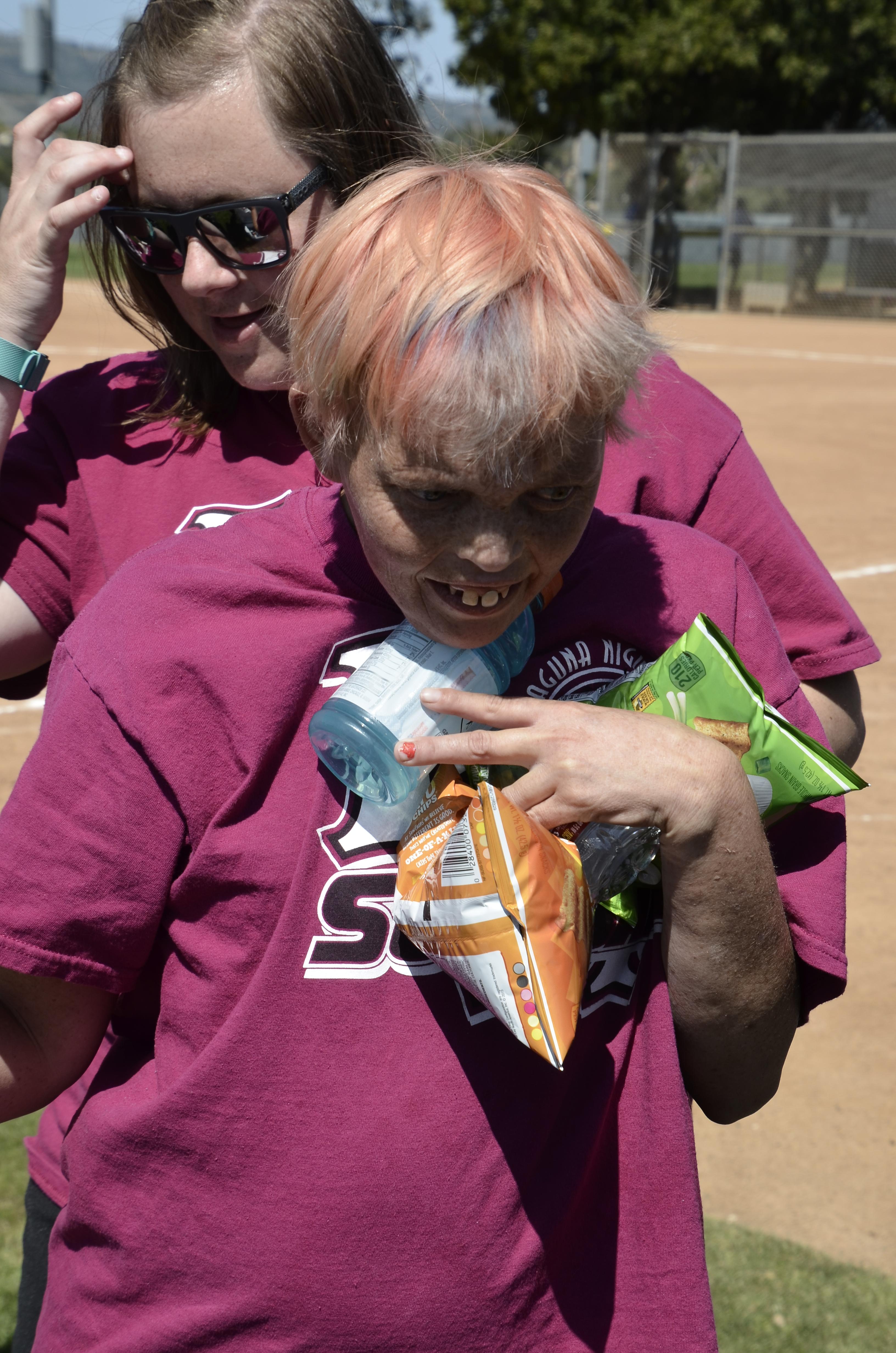Ashley is either thinking "take home," or she got some for her mom too. Ashley would always take two items from a candy dish.  One for herself and one to give to her mom or a friend. (picture from Rose Gutierrez)