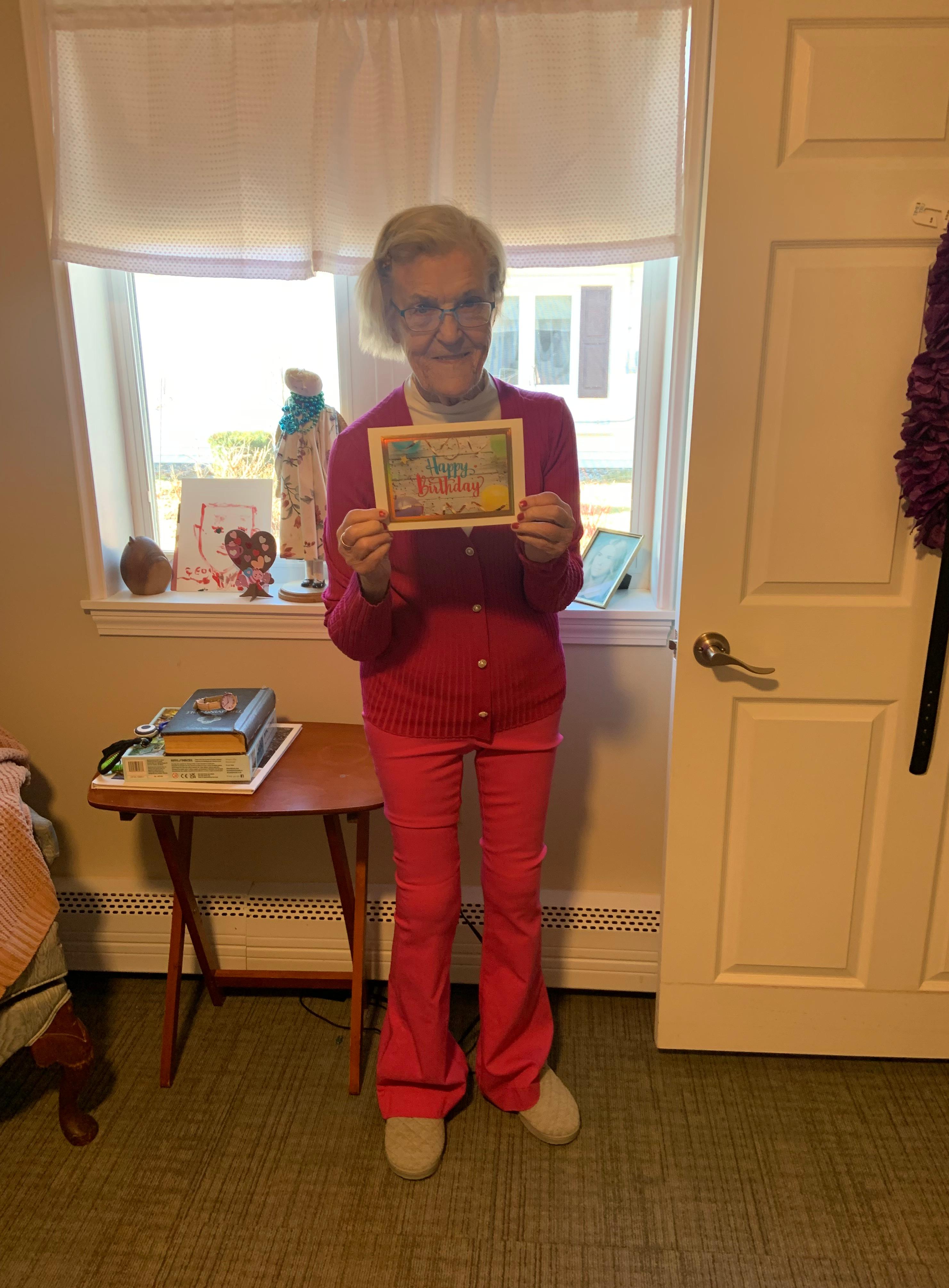 Bird holding a painting she did on her 97th birthday on March 8, 2024. Her last birthday. A carer (Sparrow), took the photo at Millview Assisted Living, Cohoes, NY