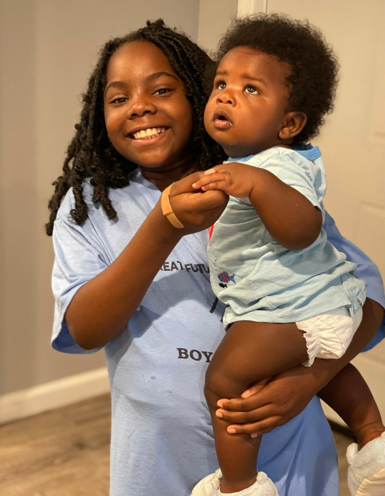 Oldest grand child holding the youngest grand child