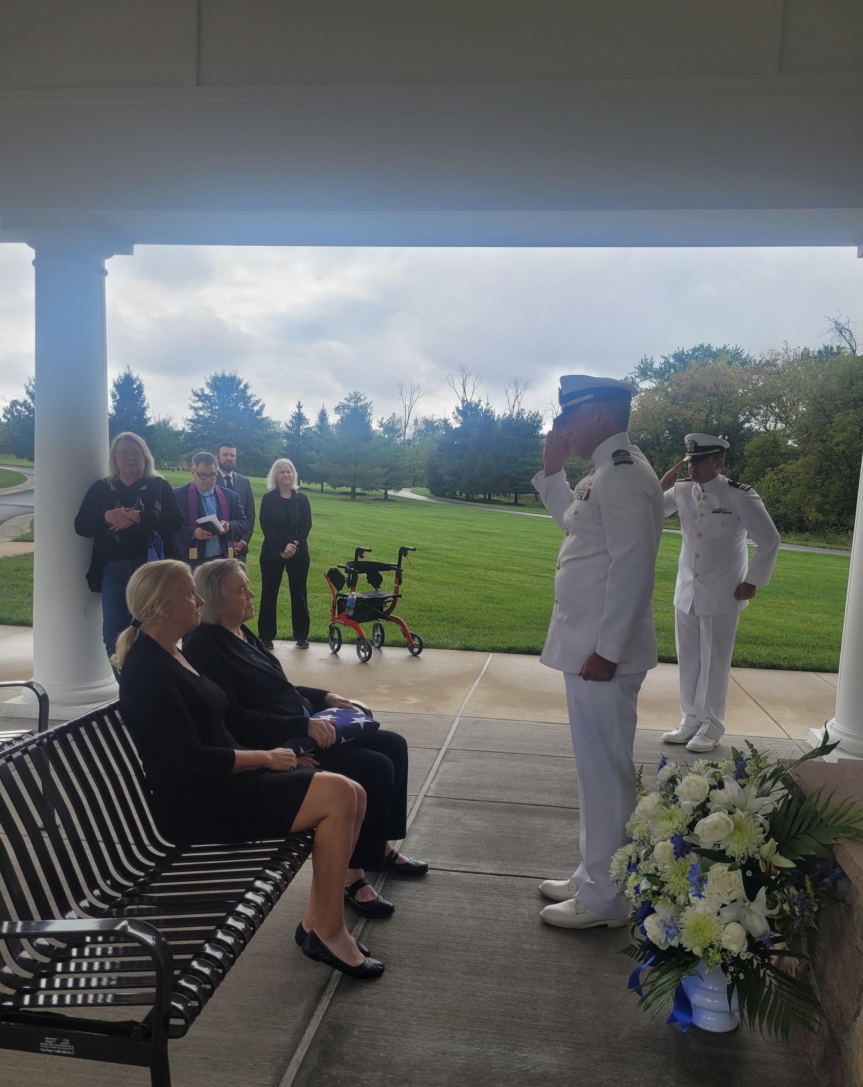 Soldier saluting Grace after receiving the American Flag