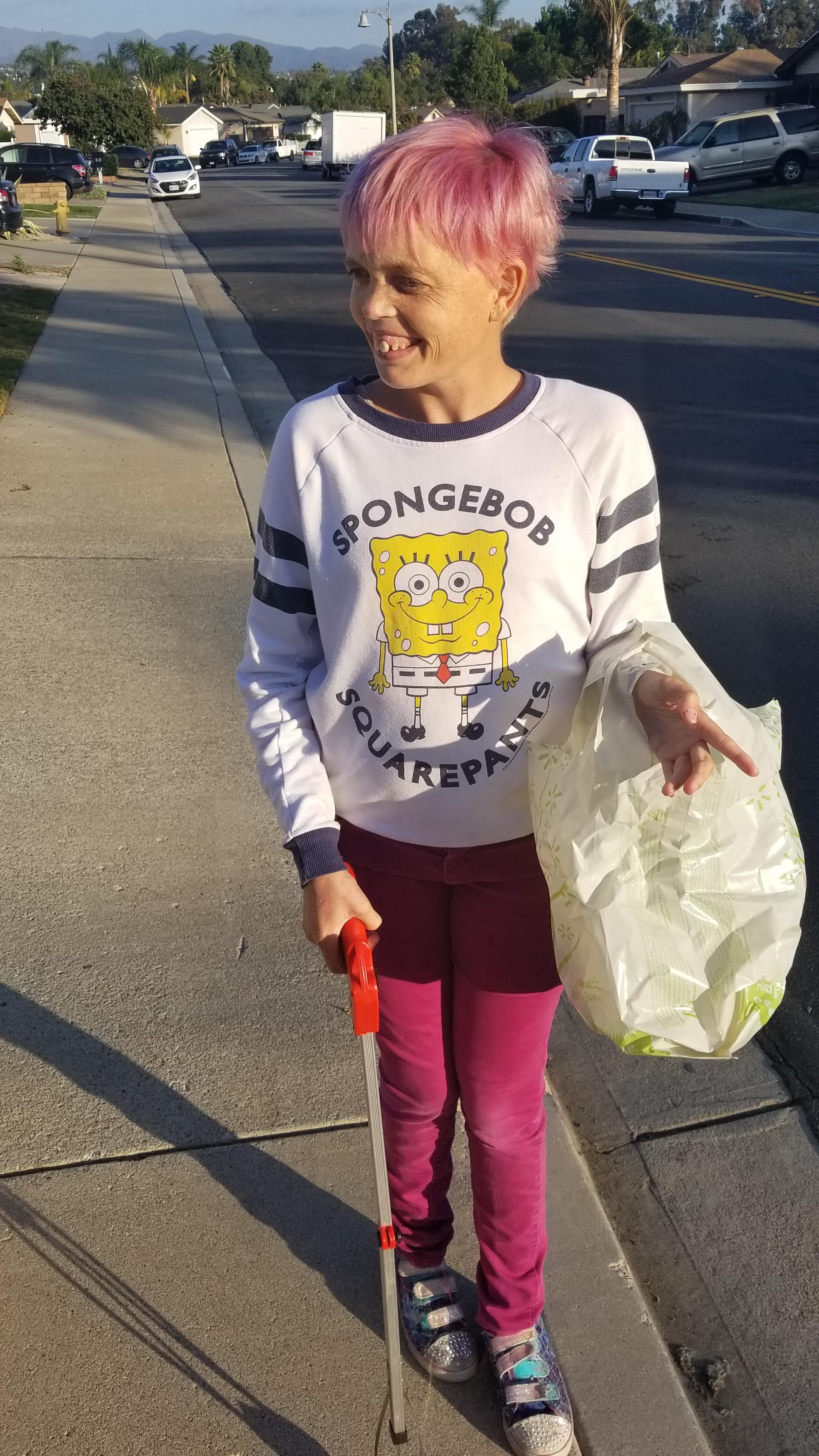 Ashley cleaning up the neighborhood and collecting recyclables.