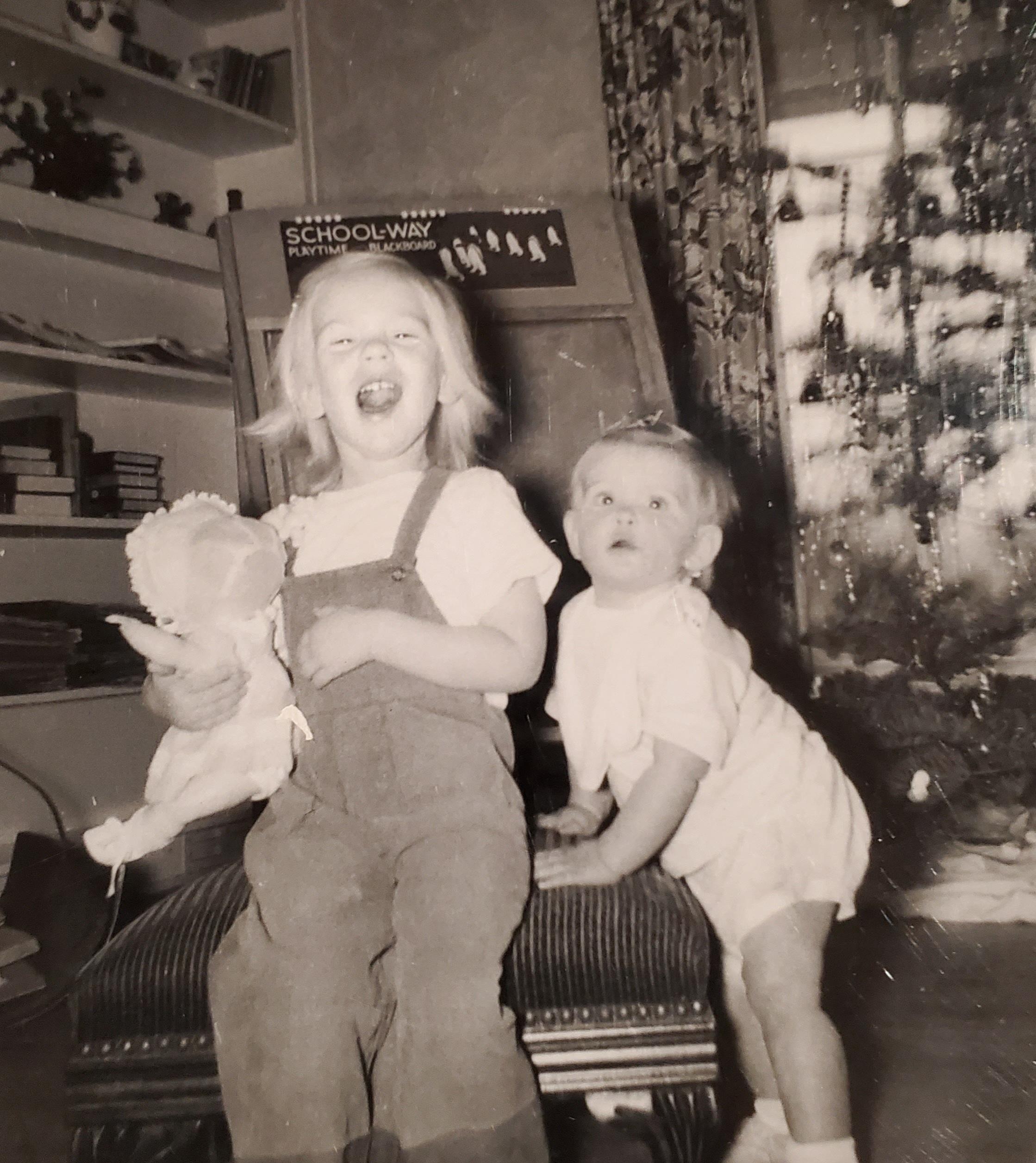 Carole (age 1) and Sandy (age 3) posing for the camera. Our father had his own darkroom and took many pics of us. It was fun going in the darkroom and watching the pictures come up on the paper while it was soaking in the developing solution. He was quite an ardent photographer. 
