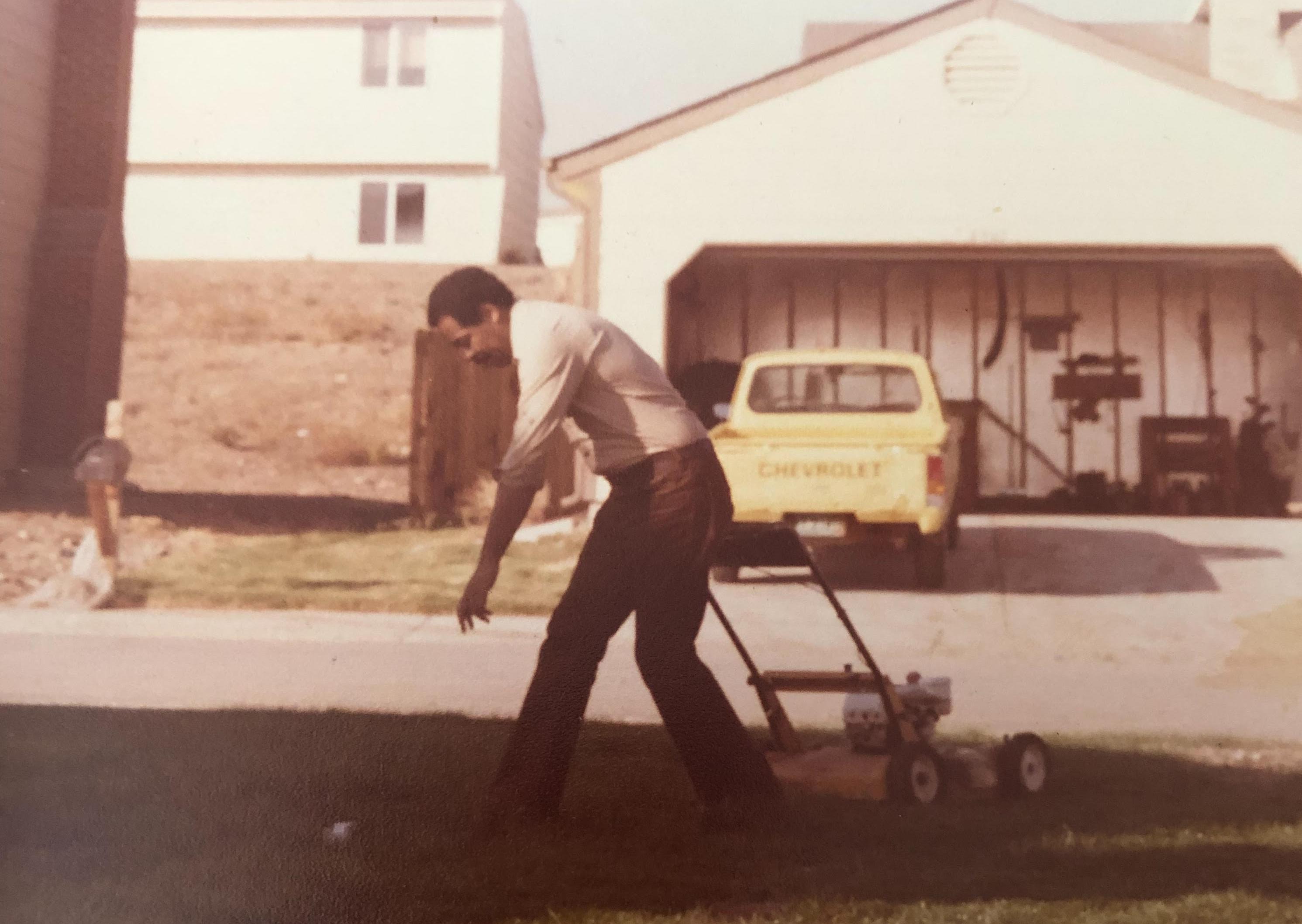 Dad mowing the lawn at our house in Colorado.