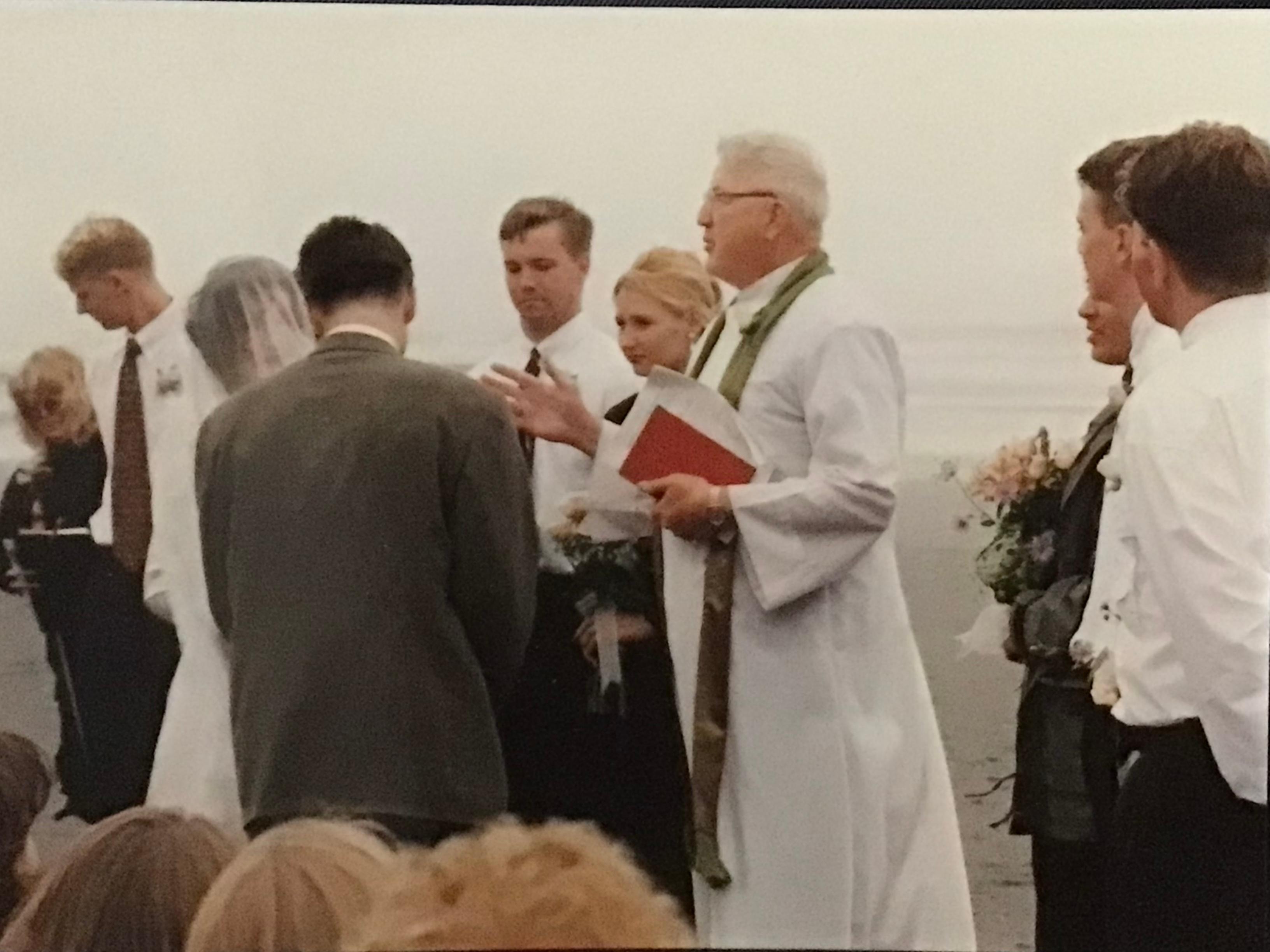 Pastor Lundeen officiating a wedding on the beach.