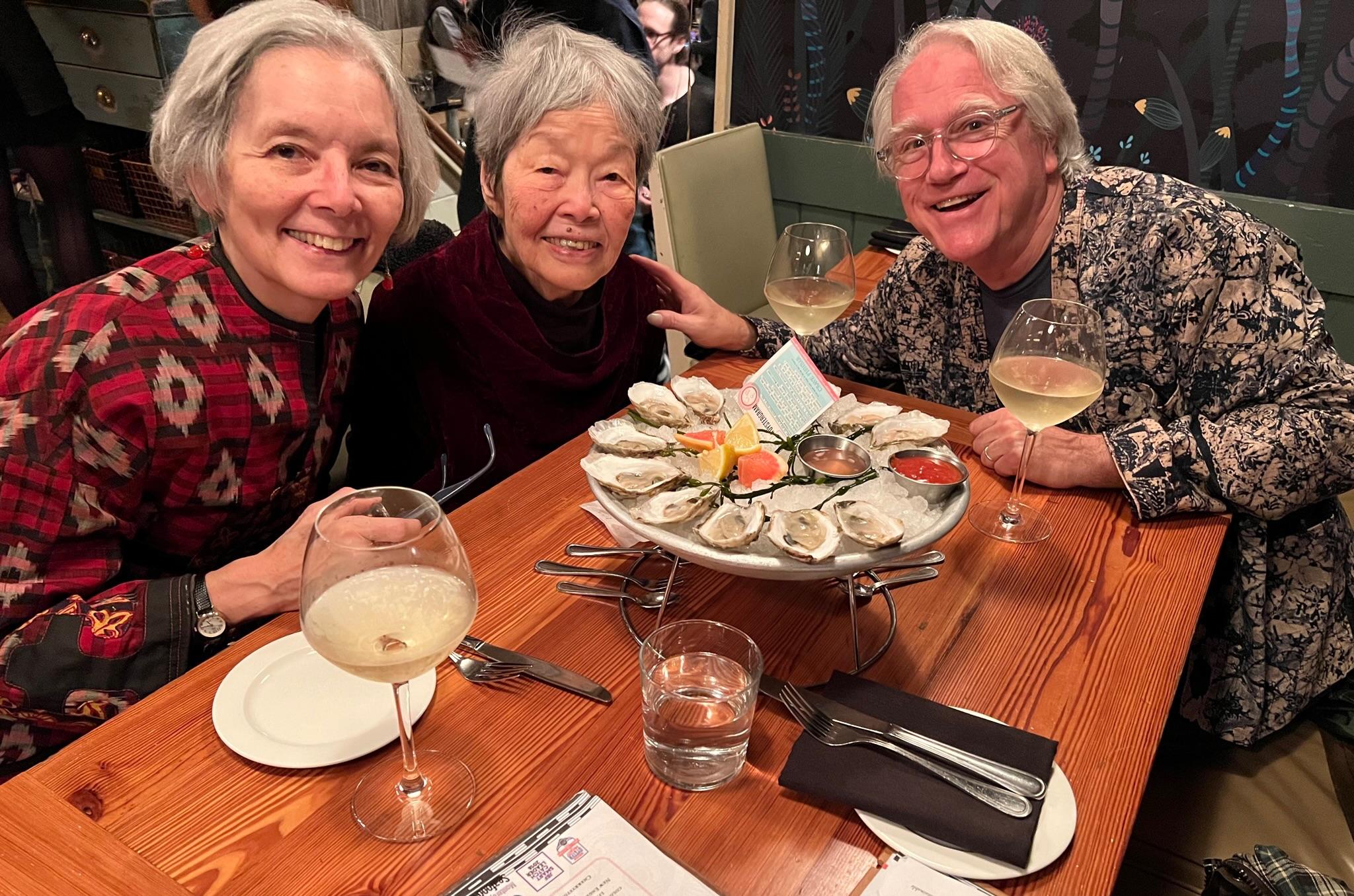 Rie, Ben, and Fumi at dinner wearing Fumi designs.